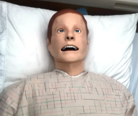 Manikin Nursing Training dummy lying in bed 