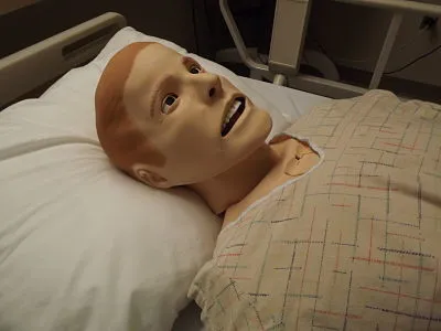 Manikin Nursing Training Dummy lying in a bed 