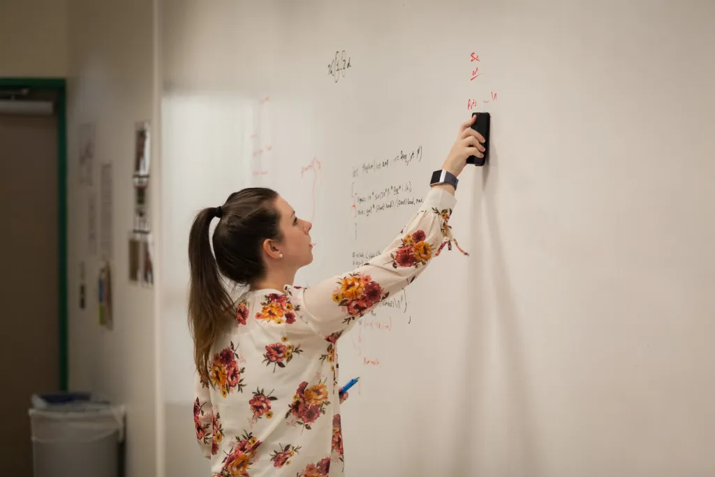 Instructor writing on board