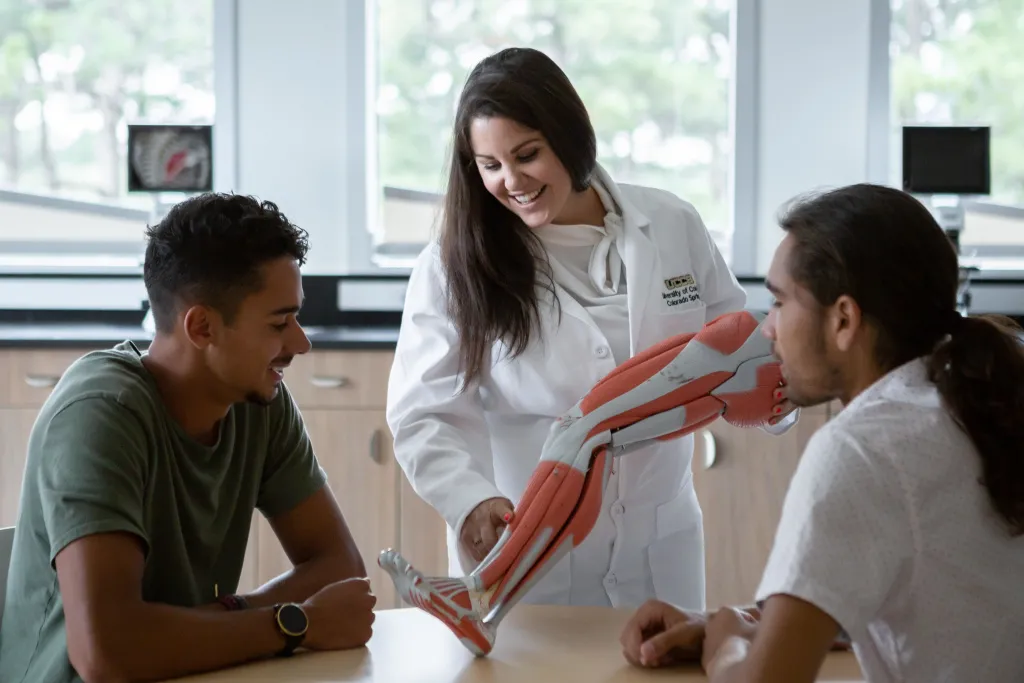 professor working with students in the classroom